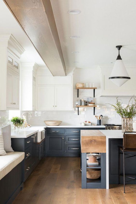a contrasting kitchen with white upper cabinets and graphite grey lower ones light colored wood touches